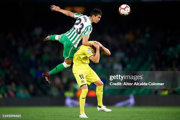 Aissa Mandi of Real Betis Balompie competes for the ball with Vicente Iborra of Villarreal CF during the La Liga match between Real Betis Balompie...