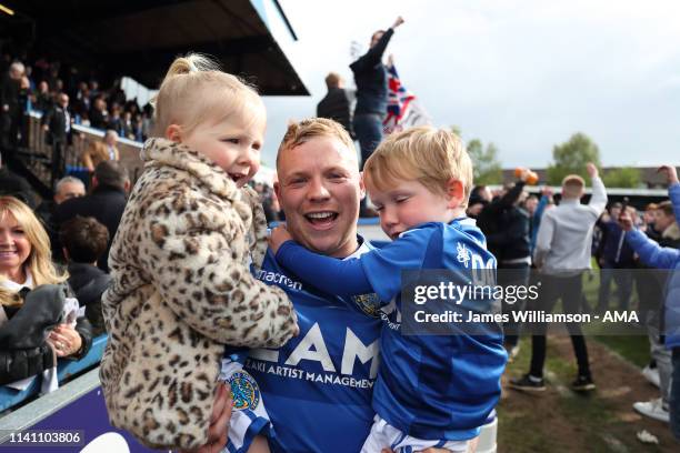 Elliott Durrell of Macclesfield Town celebrates at full time with his children at the Sky Bet League Two match between Macclesfield Town and...