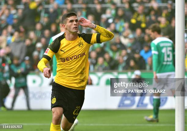 Dortmund's US midfielder Christian Pulisic celebrates scoring the opening goal during the German first division Bundesliga football match Werder...