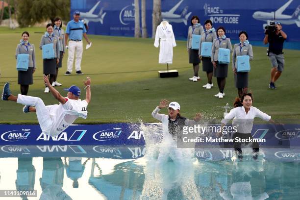 Jin Young Ko of Korea, her caddie David Brooker, and her agent Soo jin Choi, leap into Poppie's Pond next to the 18th green after her win during of...