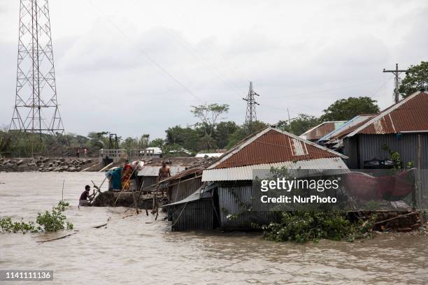 People fix their damaged homes amid high waters in Khulna on May 4 as Cyclone Fani reached Bangladesh. - Cyclone Fani, one of the biggest to hit...