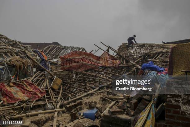 Man surveys a damaged roof after Cyclone Fani passed through Puri, Odisha, India, on Saturday, May 4, 2019. A category 4 storm with strong wind and...