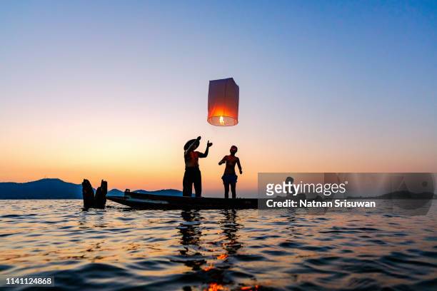 fisherman with floating lamp. - jack o lantern fotografías e imágenes de stock