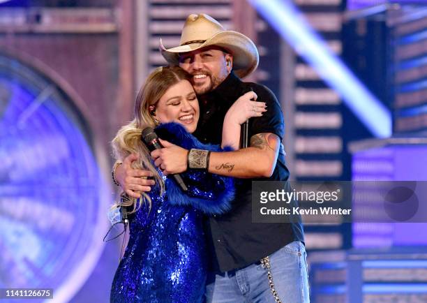 Kelly Clarkson and Jason Aldean perform onstage during the 54th Academy Of Country Music Awards at MGM Grand Garden Arena on April 07, 2019 in Las...