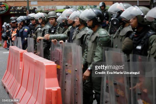 Riot police officers stand guard during a demonstration near La Casona on May 4, 2019 in Caracas, Venezuela. Venezuelan opposition leader Juan...
