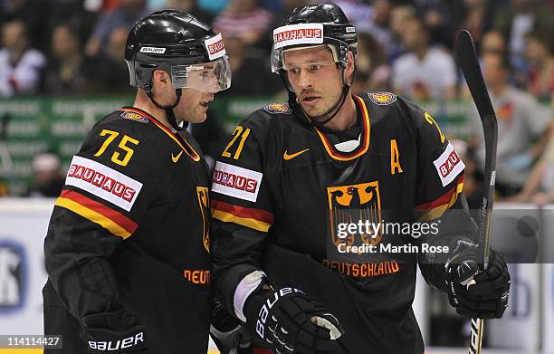 Marcus Kink of Germany talks to team mate John Tripp during the IIHF World Championship quarter final match between Sweden and Germany at Orange...