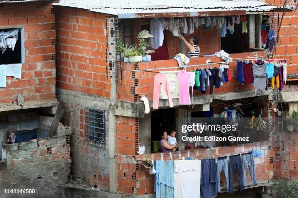 Two Venezuelan women in their homes at Barrio Cotiza neighborhood on May 4, 2019 in Caracas, Venezuela. As the country goes through a political,...