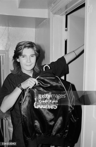 American television and film actor Corey Feldman poses with a jacket branded with 'The Goonies' on the back, a film that Feldman starred in United...