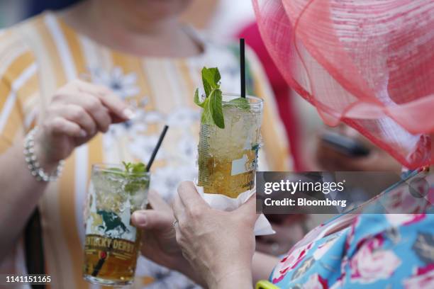 Racegoers drink mint julep cocktails before the 145th running of the Kentucky Derby at Churchill Downs in Louisville, Kentucky, U.S., on Saturday,...