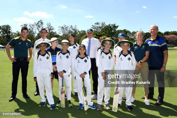 Prime Minister Scott Morrison, Men and Women's Australian Cricket captains Meg Lanning and Tim Paine pose for a photo with a local junior cricket...