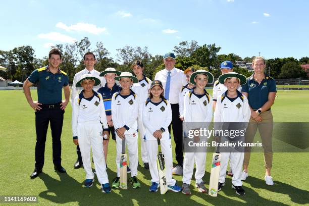 Prime Minister Scott Morrison, Men and Women's Australian Cricket captains Meg Lanning and Tim Paine pose for a photo with a local junior cricket...