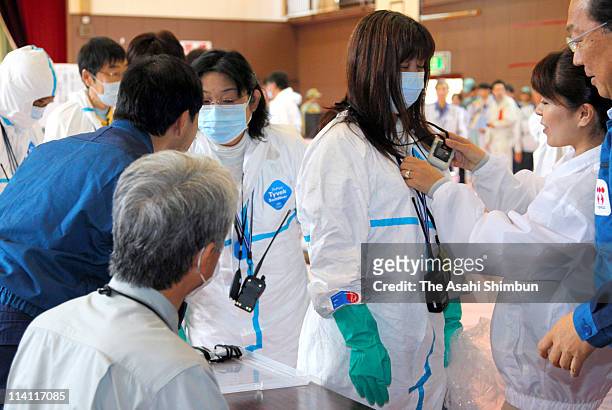 Katsurao Village residents, wearing radiation protective clothing, prepare for temporary return within the exclusion zone, 20km radius from the...