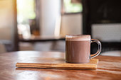 Hot chocolate or cocoa on wooden table , background