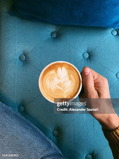 man holding cup of cappuccino, directly above view - coffee above stock-fotos und bilder