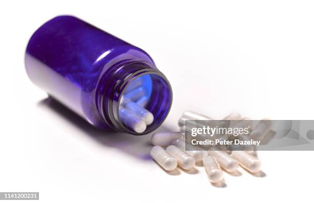 pills spilling out of pill bottle - codeine stockfoto's en -beelden