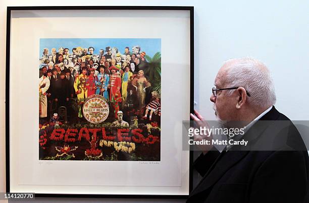 Artist Peter Blake poses for a photograph besides a copy of The Beatles Sgt Pepper LP album cover that he designed in 1967 as he reopens the Holburne...