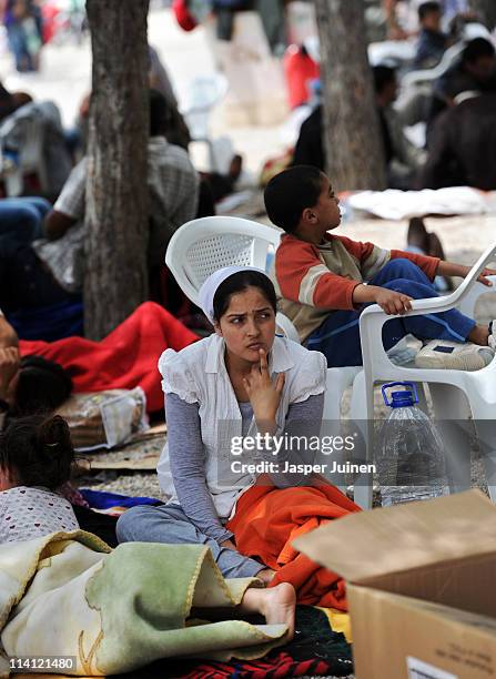 Woman waits in a park, one day after a magnitude 5.1 quake killed at least 9 people, on May 12, 2011 in Lorca, Spain. After spending the night...