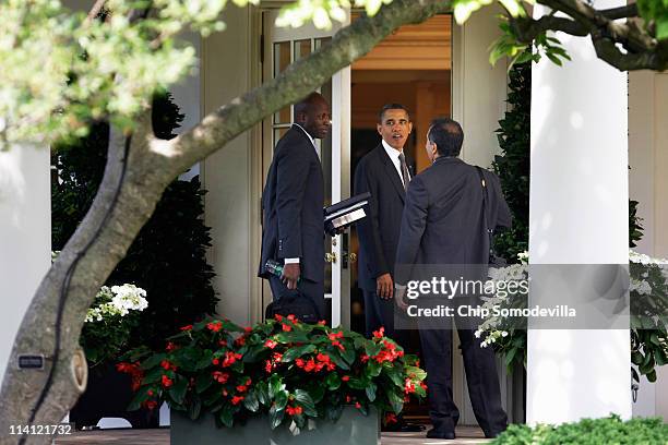 President Barack Obama talks with his special assistant and personal aide Reggie Love and photographer Pete Souza outside the Oval Office after...