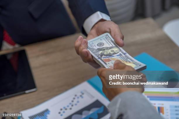 businessmen secretly passing money - bribery and corruption concepts - cash bribe スト��ックフォトと画像