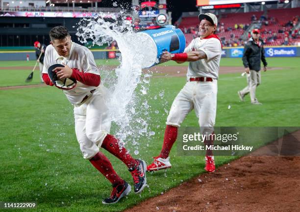 Nick Senzel of the Cincinnati Reds gets a celebratory soaking from Derek Dietrich of the Cincinnati Reds following the game against the San Francisco...