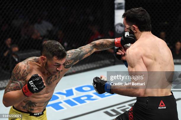 Cub Swanson punches Shane Burgos in their featherweight bout during the UFC Fight Night event at Canadian Tire Centre on May 4, 2019 in Ottawa,...