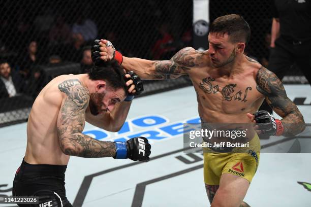 Cub Swanson punches Shane Burgos in their featherweight bout during the UFC Fight Night event at Canadian Tire Centre on May 4, 2019 in Ottawa,...