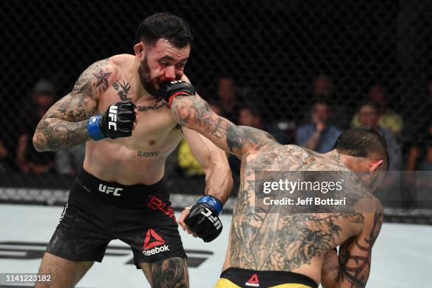 Cub Swanson punches Shane Burgos in their featherweight bout during the UFC Fight Night event at Canadian Tire Centre on May 4, 2019 in Ottawa,...