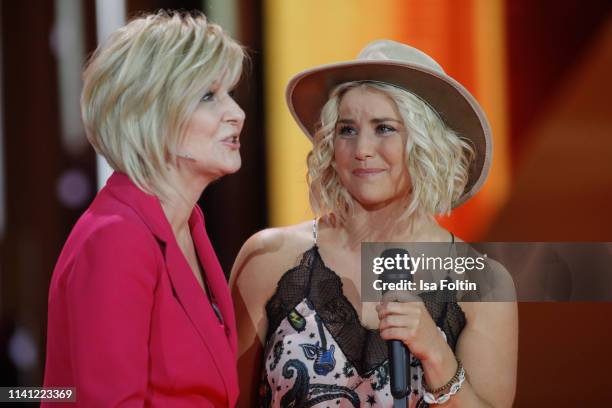 German presenter Carmen Nebel and Swiss singer Beatrice Egli speak onstage during the television show 'Willkommen bei Carmen Nebel' at Velodrom on...