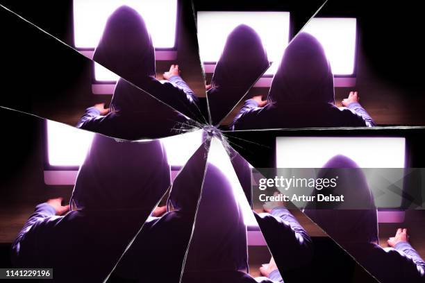 mystic picture of hacker with computer at dark room seen through a broken mirror. - broken mirrors imagens e fotografias de stock