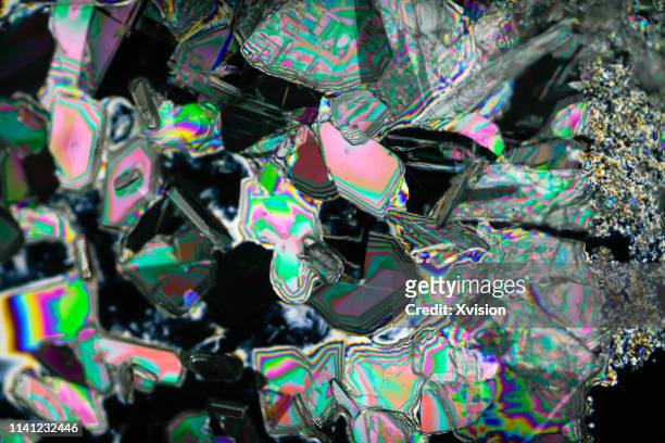barium chloride under polarized light with black background - barium stock pictures, royalty-free photos & images