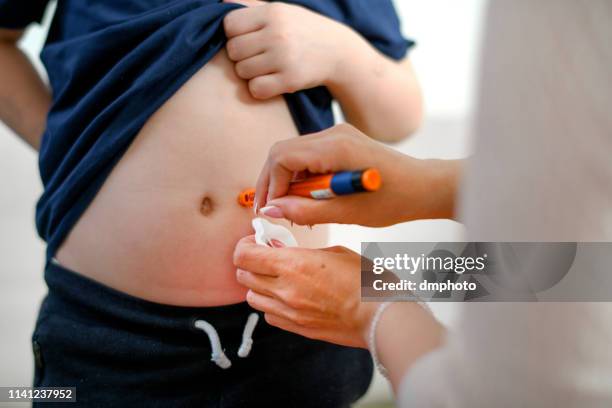 boy taking an insulin shot at stomach - injecting stock pictures, royalty-free photos & images
