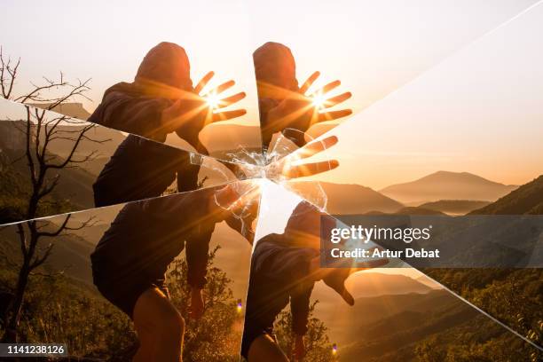 mystic picture of guy playing with sunlight during sunrise in the nature seen through a broken mirror. - cracked mirror stock pictures, royalty-free photos & images