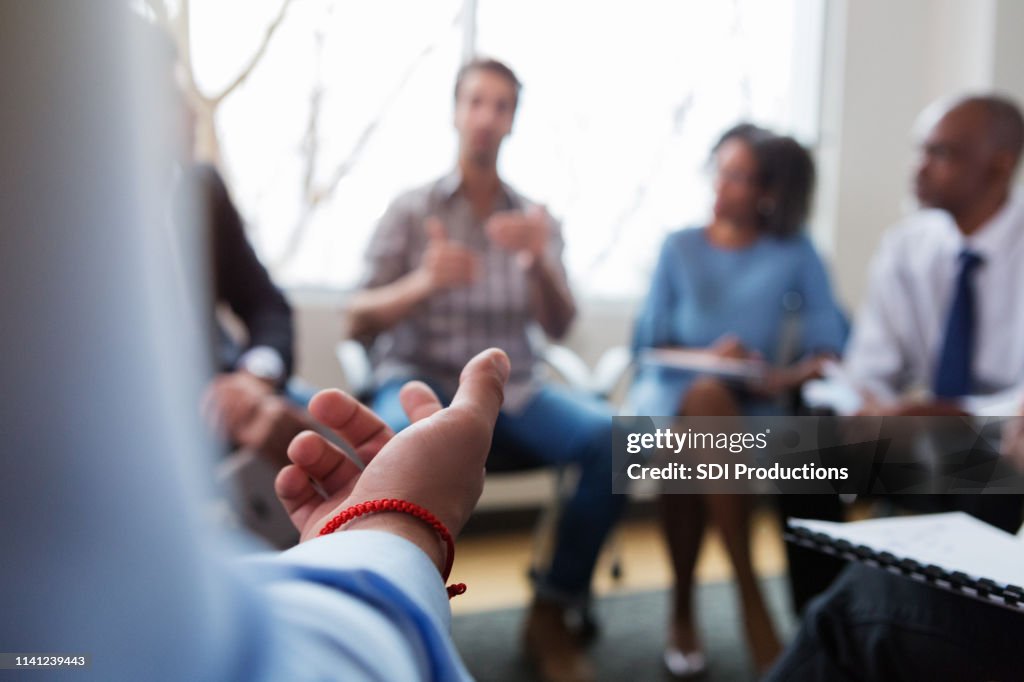 Unrecognizable business person gestures during meeting