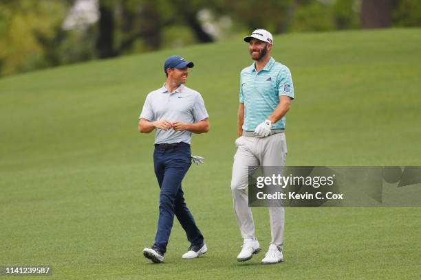 Rory McIlroy of Northern Ireland and Dustin Johnson of the United States share a laugh during a practice round prior to The Masters at Augusta...