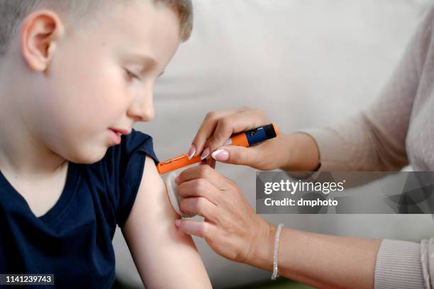 cute child taking an insulin shot - injecting pen stock pictures, royalty-free photos & images