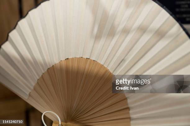 chinese, japanese style white folding fan - folding fan stock pictures, royalty-free photos & images