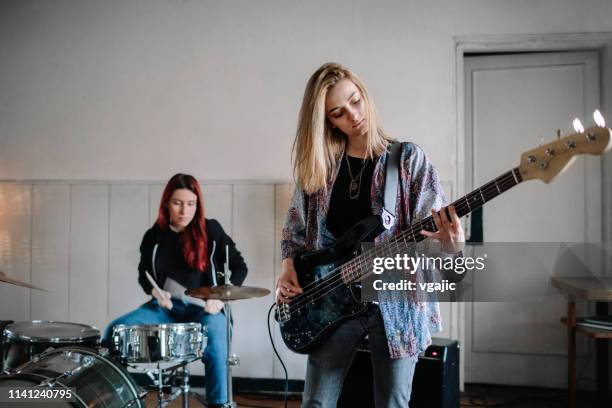 generation z female music band on rehearsal - bass guitarist stock pictures, royalty-free photos & images