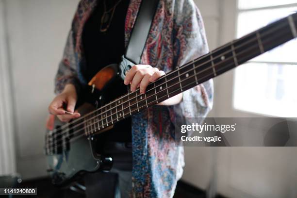 girl with electric bass guitar - bass guitar stock pictures, royalty-free photos & images