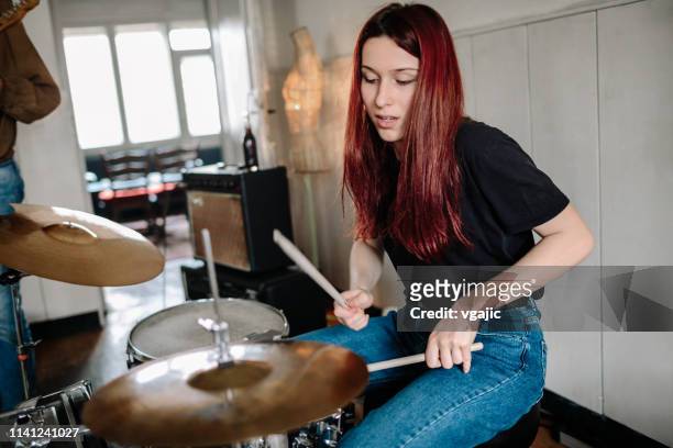 baterista femenino en el ensayo - playing drums fotografías e imágenes de stock