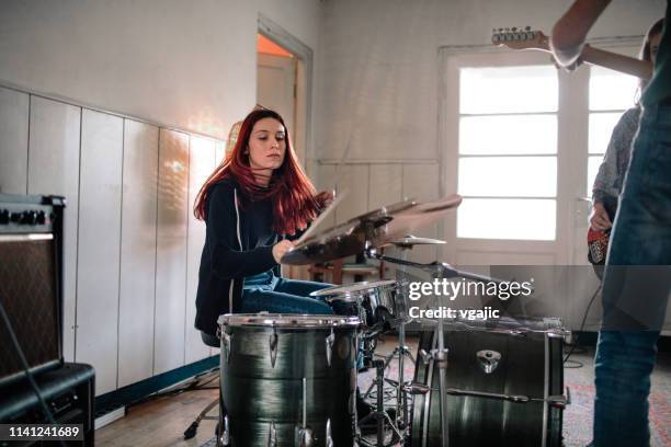 female drummer on rehearsal - drummer stock pictures, royalty-free photos & images
