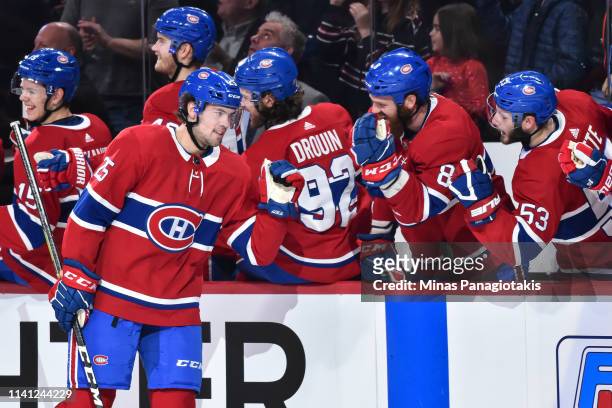 Ryan Poehling of the Montreal Canadiens celebrates his first career NHL goal in his first game at 11:41 of the first period with teammates on the...
