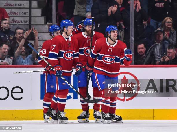 Ryan Poehling of the Montreal Canadiens celebrates his first career NHL goal in his first game at 11:41 of the first period and is joined by Jordan...