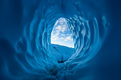 Morning in the Alaskan wilderness. Clouds seen at sunrise from inside a large blue ice cave on the Matanuska Glacier