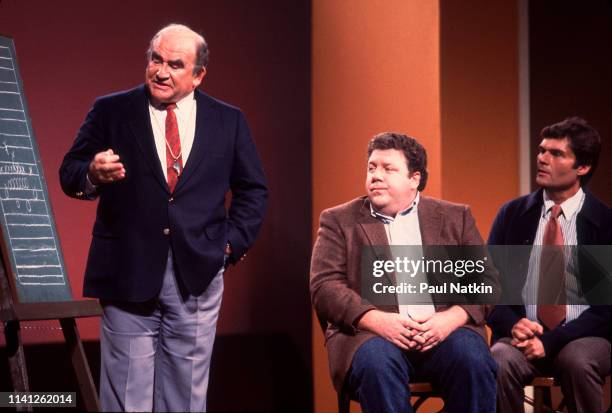 View of American actors, from left, Ed Asner, George Wendt, and Fred Willard as they perform onstage during the Second City 25th Anniversary...