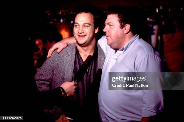 View of American comedians Jim Belushi and George Wendt as they are interviewed outside the Second City 25th Anniversary performance at the Vic...