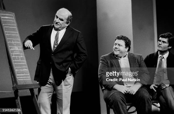 View of American actors, from left, Ed Asner, George Wendt, and Fred Willard as they perform onstage during the Second City 25th Anniversary...