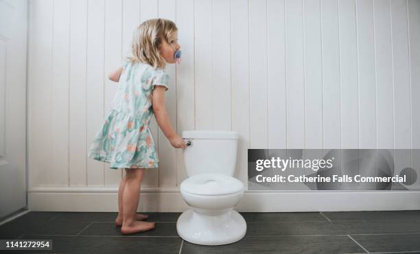 potty training - girls peeing stock pictures, royalty-free photos & images