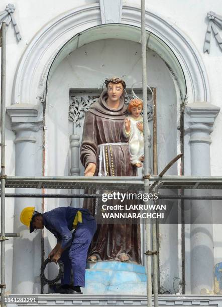 Sri Lankan navy personnel carry on repair works on the facade of St. Anthony's Shrine in Colombo on May 5 two week after a series of bomb blasts...