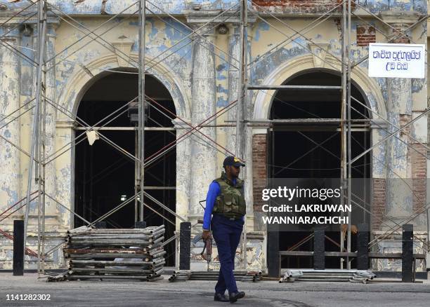 Sri Lankan soldier stands guard outside St. Anthony's Shrine in Colombo on May 5 two week after a series of bomb blasts targeting churches and luxury...