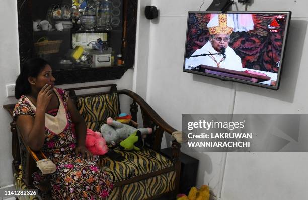 Sri Lankan Christians watch a live broadcast of a service conducted by the Archbishop of Colombo Cardinal Malcolm Ranjith, at their house near St....